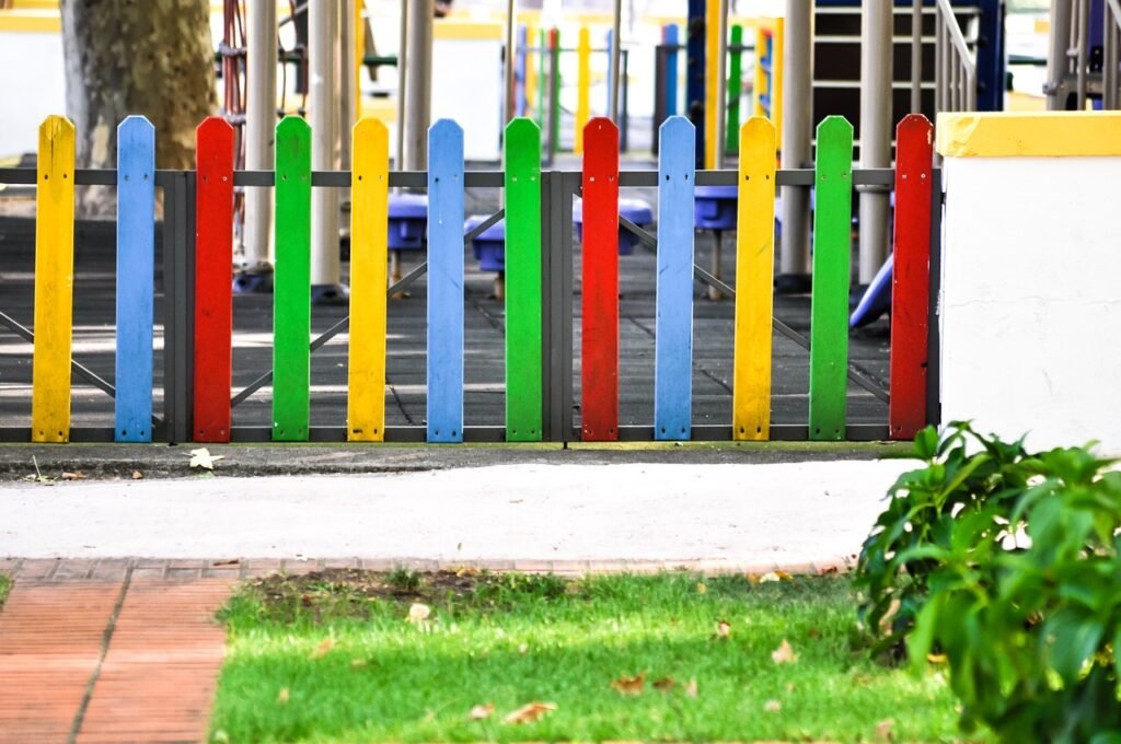 play area, playground, fence, colourful, bush, golden light, sunny, kids, fun, children, play, school yards, school yard fence, kindergarten fence, kindergarten play yard, outsider, nature, play park, park, kids park, play area, play area, play area, play area, play area