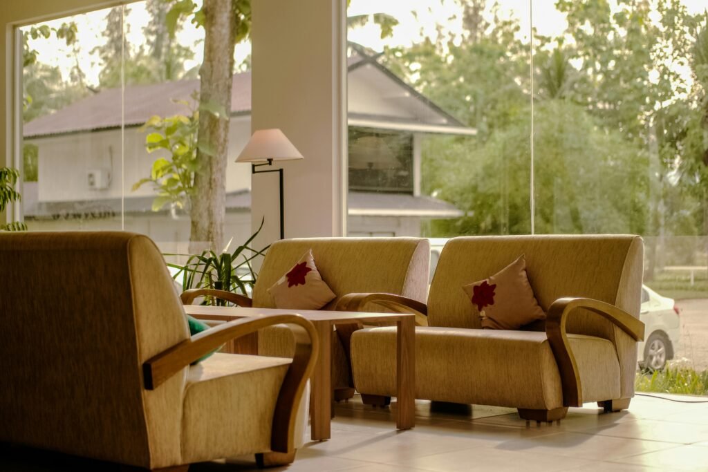 Elegant lobby with comfortable sofas, large windows, and natural light enhancing the indoor ambiance.