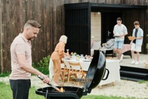 A happy family enjoys an outdoor barbecue in their backyard, fostering togetherness.